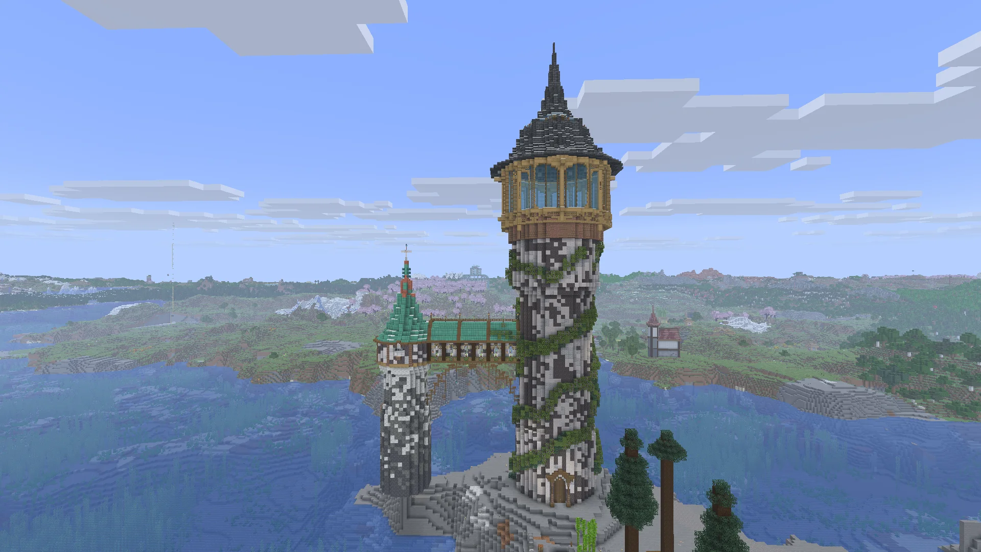 Two detailed survival towers built beside a broad lake in a Fixed by Design world.